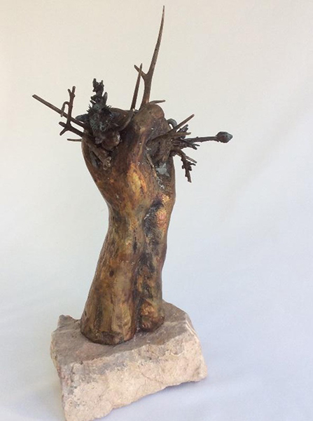 Alice Bordenkircher Tavani, Fallacious Restraint, 2016. Hand holding natural materials on rock support.