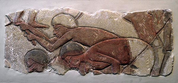 Ancient Egyptian sandstone relief titled Talatat: Men Hoeing the Ground (ca. 1353–1336 BCE). Relief carving with figures digging clay painted in reds and browns.