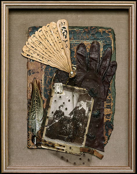 Assemblage by Betye Saar titled The Differences Between (1989). Framed assemblage with a photograph of a couple, leather glove, and wood fan.