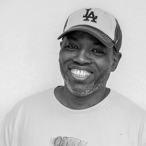 Black-and-white photograph of artist Cey Adams.