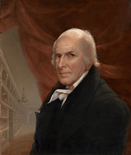 Oil painting by Charles Willson Peale titled Self-Portrait in the Museum (1822). Balding man in front of a red curtain and room with wall of shelves in the background.