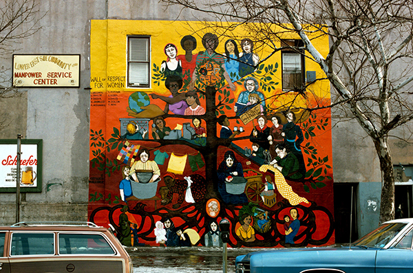 Mural by Tomie Arai and Cityarts Workshop titled Wall of Respect for Women (1974). Chinese, Italian, Jewish, Puerto Rican, African American, and white women are depicted on the branches and roots of a tree in a variety of occupations.