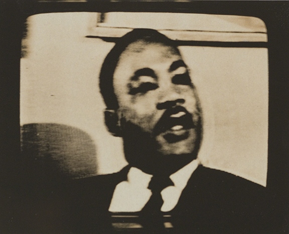 Photograph by Dean Brown from his Martin Luther King Jr. Funeral series. Black-and-white image of Martin Luther King, Jr. taken from a television broadcast.