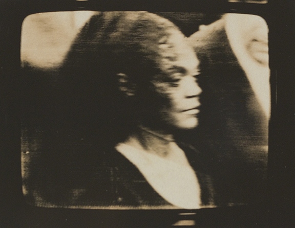 Photograph by Dean Brown from his Martin Luther King Jr. Funeral series. Black-and-white image of a woman at Martin Luther King, Jr.'s funeral taken from a television broadcast.