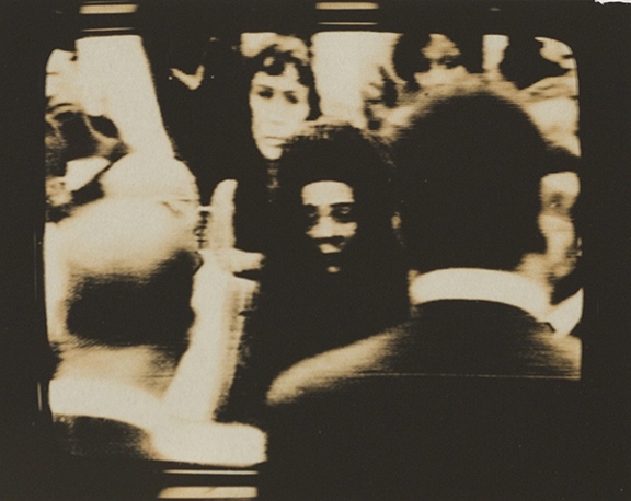 Photograph by Dean Brown from his Martin Luther King Jr. Funeral series. Black-and-white image of people at Martin Luther King, Jr.'s funeral taken from a television broadcast.
