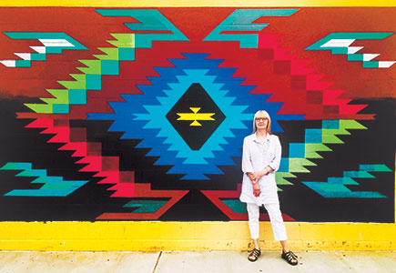 Nancy with a mural at the Chimayo Elementary School in Chimayo, New Mexico.