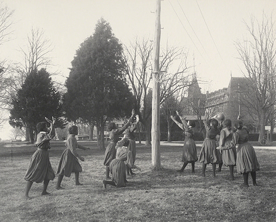 Photograph by Frances Benjamin Johnston titled Girls’ Basket Ball (sic) (1899-1900). Black-and-white photograph of women playing basketball.