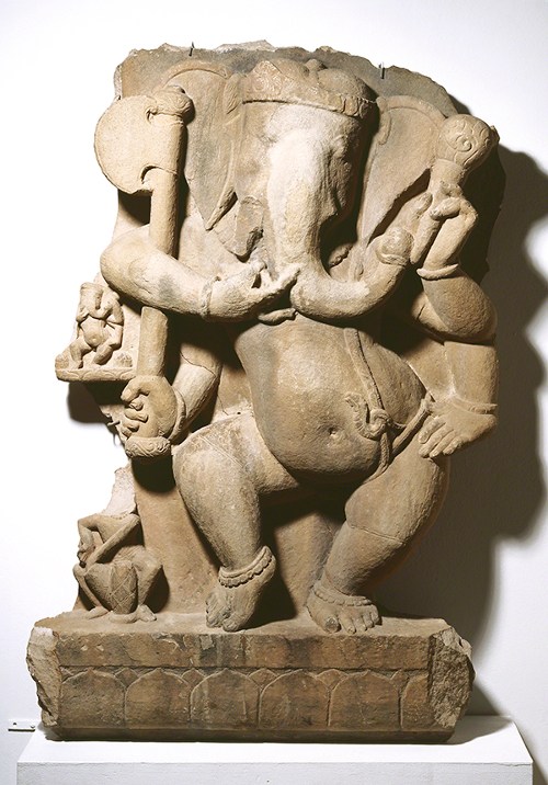 Sandstone sculpture from India of Ganesa (or Ganesha) Dancing (ca. 750 CE). Figure with the head of an elephant and body of a toddler boy.