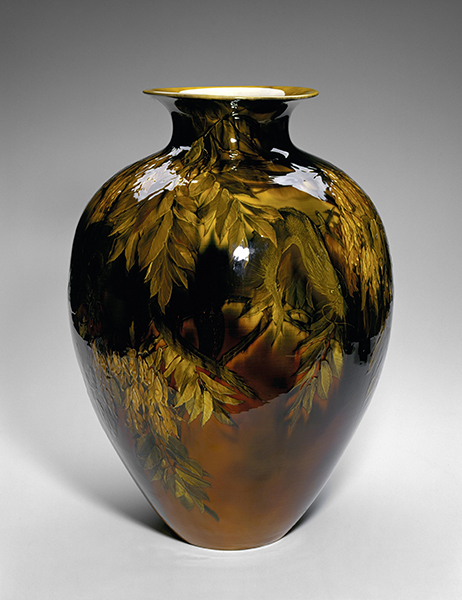 Vase painted by Kitaro Shirayamadani for Rookwood Factory titled Imperial Dragon Vase (1892). Vase with dark black and brown glaze and yellow painted leaf designs.