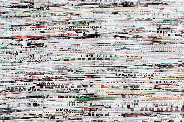 Wallpaper design by Lori Weitzner titled Newsworthy (2009/2010). Horizontal strips of newspaper woven together with nylon thread.