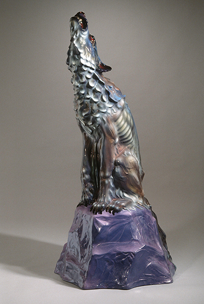Fiberglass sculpture by Luis Jiménez titled Howl (1986). A howling coyote sits atop a purple rock.