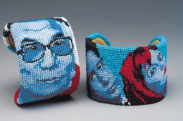 Beadwork art by Marcus Amerman titled Dalai Lama and X-Files (1999). Bracelets with blue and red beads depicting the face of the Dalai Lama on one and Mulder and Scully on the other.