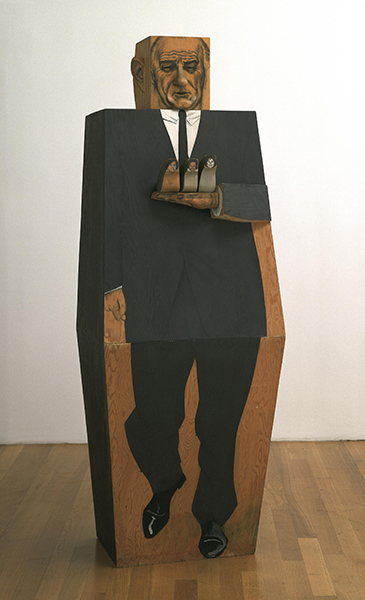 Wooden sculpture by Marisol titled LBJ (1967). Blocky, coffin-shaped sculpture of president Lyndon Baines Johnson holding small figures of his wife (Claudia "Lady Bird" Johnson) and two daughters (Lynda Bird Johnson Robb and Luci Baines Johnson Turpin).