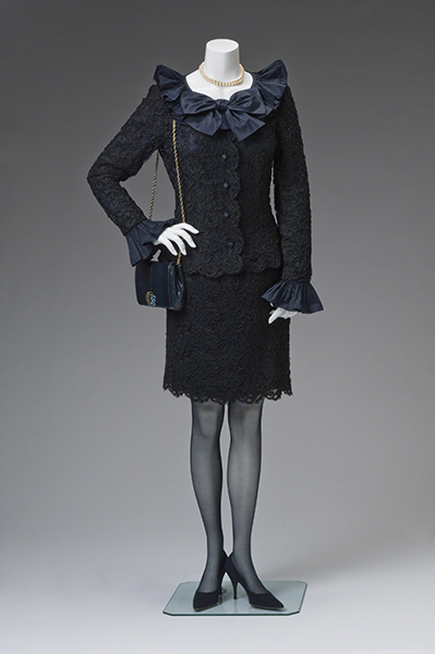 Oscar de la Renta Cocktail Suit (1980s). Black lace suit jacket and skirt with silk ruffles at the wrists and collar.