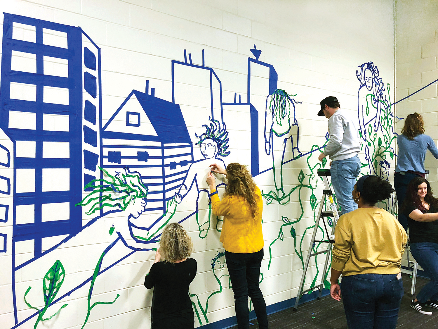 Students creating a collaborative mural using PiktoTape