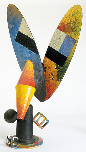 Sculpture by Robert Hudson titled Jack Rabbit (1985). Abstract, cast bronze sculpture made from assemblage of objects, painted orange, yellow, blue, green, black, and white.
