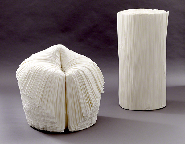 Chair designed by Oki Sato titled Cabbage Chair. Chair made from layers of white paper shown open and as closed cylinder.