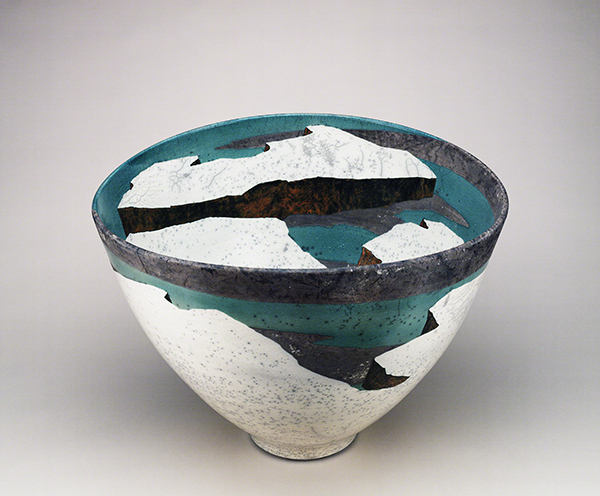 Ceramic work by Wayne Higby titled Frozen Day Mesa (1984). Bowl form with raku surface design in white, black, and teal resembling a snowy landscape.