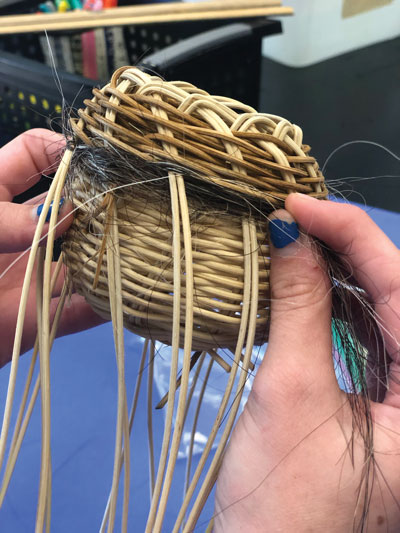 https://www.davisart.com/sites/default/assets/Image/Weintraub_SchoolArts_Weaving-Nests_Student-Weaving-her-horses-hair-into-nest-basket.jpg