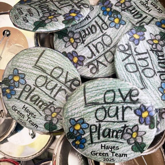 Green Team students repurposed old button bins with their own designs.