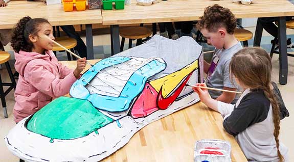 Through a giant cardboard shoe project, students visualized their carbon footprint.