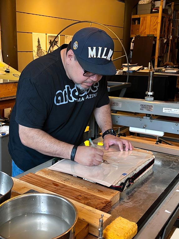 Frank learning how to create a lithography stone at the Todd Mrozinksi Studio in Milwaukee, Wisconsin.