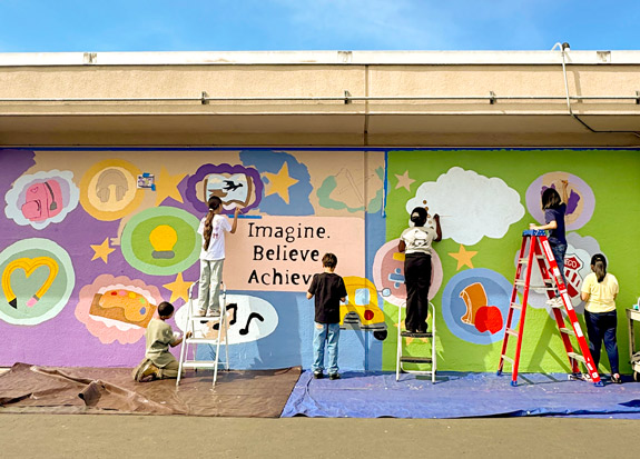 Fifth-grade students leave their mark on the school with a legacy mural inspired by the theme, What has been your favorite memory of Zamorano Fine Arts Academy