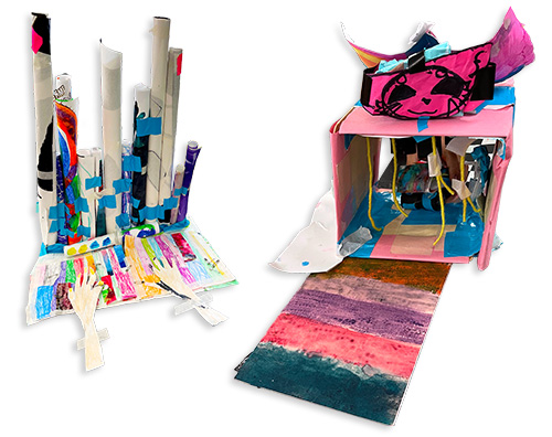Left: A pipe organ sculpture with paper hands to play it. Right: A mixed-media sculpture of a car wash. From the article Unwanted Artwork Olympics in which elementary students participate in an art challenge utilizing discarded works to create something new.