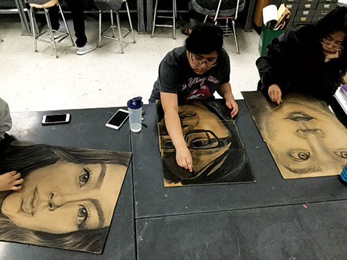 Student artwork from Charcoal Cardboard Self-Portraits, a High School art lesson