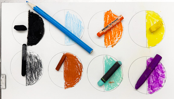 A hands-on station encourages experimentation with color and texture using a variety of media.