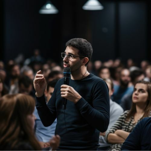 Person asking a question during the interactive panel discussion, Our Responsibility in Navigating, Advocating, & Championing Arts Education.