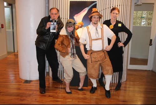 Office fun for a United Way event, with Wyatt as Robert Mapplethorpe, Jess as Amelia Earhart, Robb as a Bavarian reveler, and Lydia as Marie Curie.