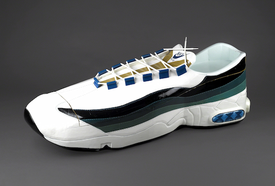 Sculpture by Paa Joe titled Nike Sneaker Coffin.